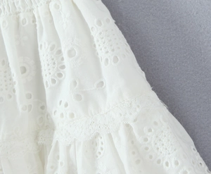Detail of white Broderie Anglaise embroidery with delicate lace layers and elastic waist