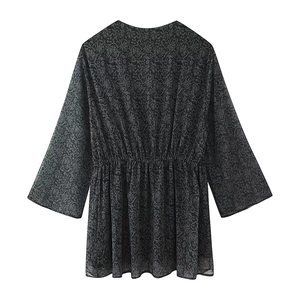 Detail of grey printed chiffon top featuring elastic waist and intricate damask pattern