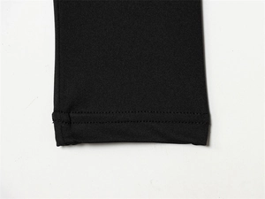 Detailed close-up showing reinforced double-needle stitching on black knit bodysuit sleeves