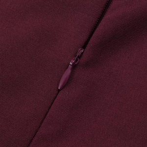 Detailed close-up of a matching invisible zipper on a slim-fit dark red summer dress