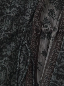 Macro view of metallic thread fabric and drawstring detail on vintage floral dress