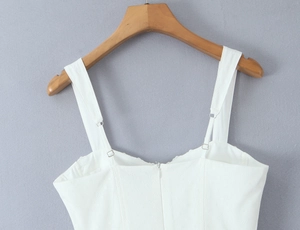Detail of white mesh summer dress showing adjustable straps and back zipper closure