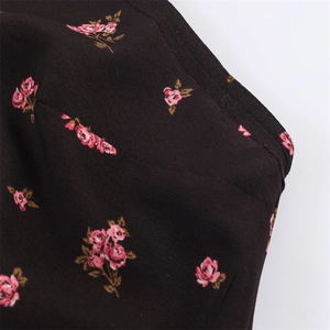 Gros plan détaillé de l'imprimé floral rose sur mousseline noire avec double couture