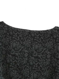 Macro view of round neckline with dark vintage jacquard pattern on vertical stripe fabric
