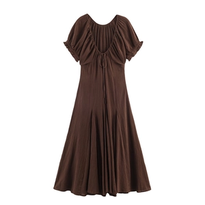 Detail view of brown short sleeve dress with puff sleeves and tie V-back design