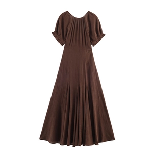 Detailed view of dark brown midi dress featuring puff sleeves and textured crepe fabric