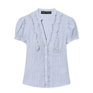 Detail view of the V-neckline with delicate ruffles on the blue striped cotton shirt