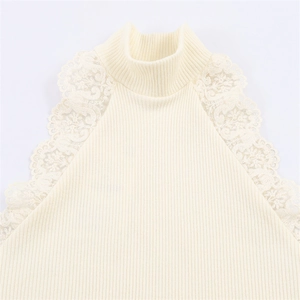 Close-up of mock neck knit top featuring floral lace detailing on the shoulder