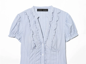 Detail of blue and white striped short sleeve shirt with ruffled V-neck and puff sleeves