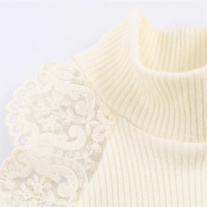 Detailed macro view of cream-white ribbed knit fabric with floral lace trim on the collar