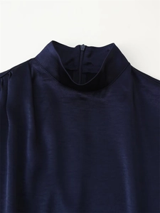 Detail of navy blue satin dress showing elegant mock neck and invisible back zipper