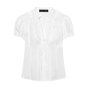 Detail of white slim-fit blouse featuring ruffled V-neckline and stand-up collar design