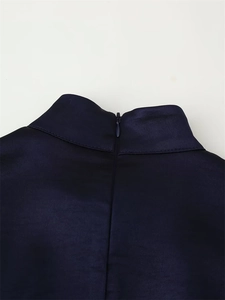 Close-up of the invisible zipper and high-quality stitching on the blue satin dress neck