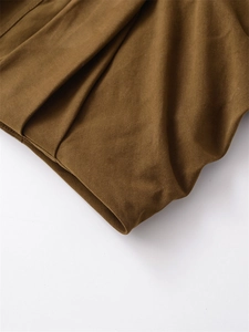 Detailed macro view of the premium camel twill fabric and high-quality hem finishing