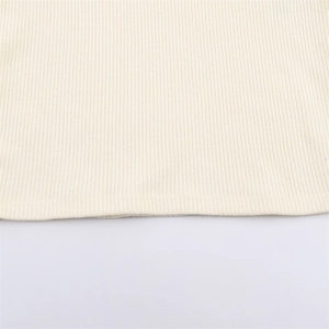 Detailed macro shot of cream white ribbed knit fabric texture and high-quality hem finish