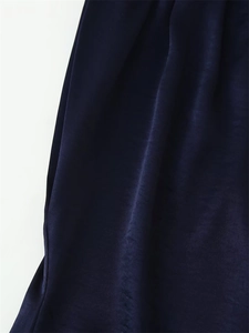 Close-up of deep blue satin fabric detail with elegant glossy texture and smooth drapes