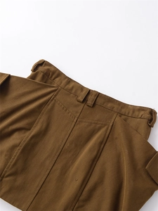 Macro view of tan workwear skirt waistline featuring cargo pockets and stitch detail