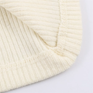 Close-up of fine ribbed knit texture and premium edge stitching on cream T-shirt