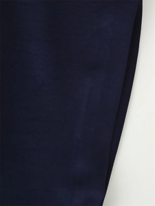 Detailed close-up of navy blue lace stitching fabric with a refined matte texture