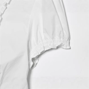 Elegant white cotton blouse with puff sleeves and ruffled elastic cuffs, casual style