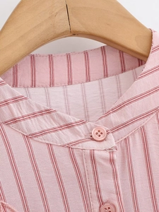 Close-up of pink striped shirt collar with matching buttons and fine fabric texture