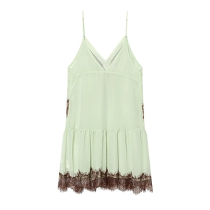 Detailed view of light green slip dress with delicate dark brown eyelash lace trim
