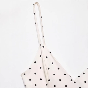 Sleeveless V-neck white dress with black polka dots and slim fit design for women