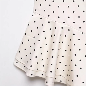 Polka dot ruffled tiered dress in cream and black minimalist lightweight fabric
