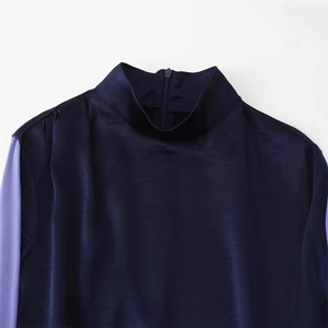 Navy blue satin high-neck top with lavender contrast sleeves and back zipper closure