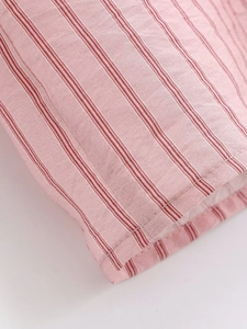 Detailed close-up of pink striped fabric showing quality stitching and textile texture