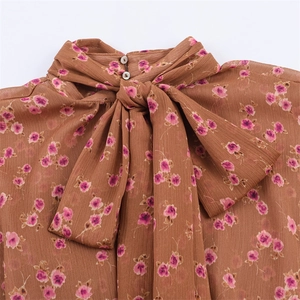 Brown floral chiffon blouse with high neck, pearl buttons and large bow detail