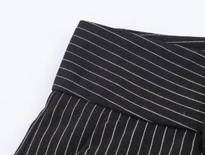 Detailed close-up of high-quality black and white pinstripe fabric and waist stitching