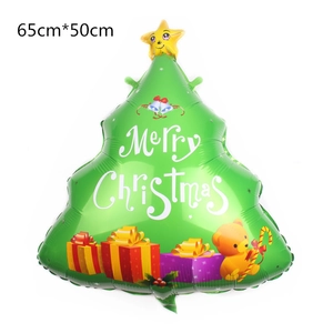 Close-up of a green Christmas tree foil balloon with Merry Christmas text and gift box motifs
