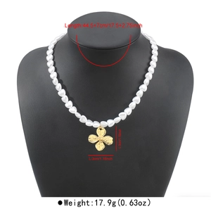 Detailed view of heart pearl necklace with gold cross pendant and size markings.