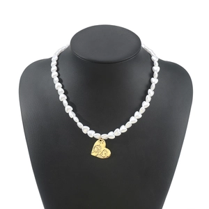 Detailed view of French vintage heart pearl necklace with gold heart pendant