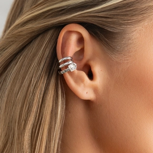 Detailed macro view of a silver triple-layered ear cuff with emerald cut zircon stone