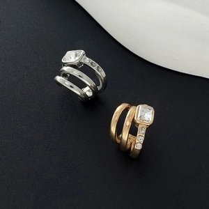 Macro detail of gold and silver multi-layer ear cuffs with square zircon and small crystals