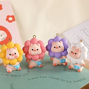 Close-up of four cute pink piggy charms with colorful sunflower headwear and blue heart bags