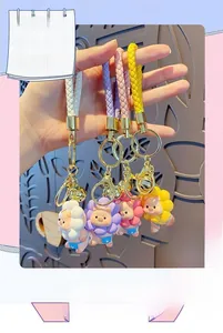 Detail of cute cartoon lion keychains with sunflower hats in four vibrant colors