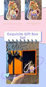 Detail of resin sunflower pig keychain with golden bell and orange gift packaging box