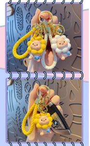 Detail of pink pig keychains with sunflower headbands and colorful braided leather straps