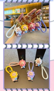 Detail of pink pig keychains with colorful sunflower hoods and woven leather straps