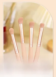 Macro view of 4-piece professional eye makeup brush set with soft beige handles