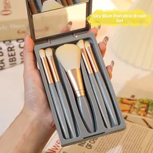 Close-up of portable 5-piece makeup brush set in grey case with built-in mirror
