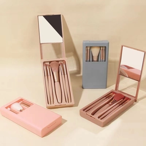 Detailed view of portable 5-piece makeup brush set with mirrored case and clear window