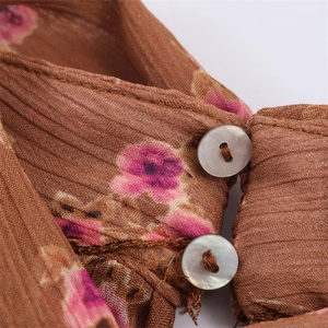 Brown floral pleated women's top with pearlescent buttons and a romantic spring print