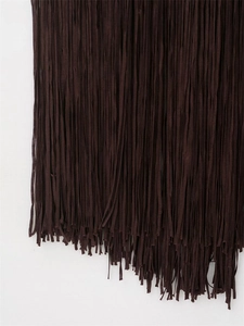 Detail of dark brown long fringe trim showing texture on a slim fit tassel dress
