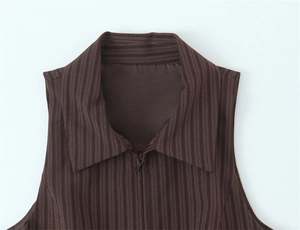 Macro detail of dark brown pinstripe vest featuring a pointed collar and hidden zipper