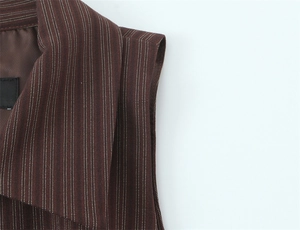 Detailed close-up of brown striped vest with notched lapel and woven fabric texture