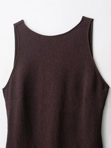 Detailed view of dark purple sleeveless dress with textured waffle fabric and U-neckline